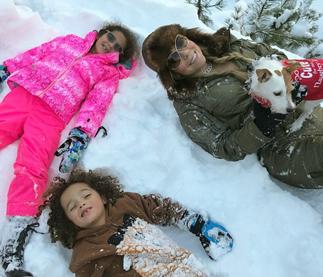 Mariah Carey rocks Dior snow boots while sledding | mcarchives.com