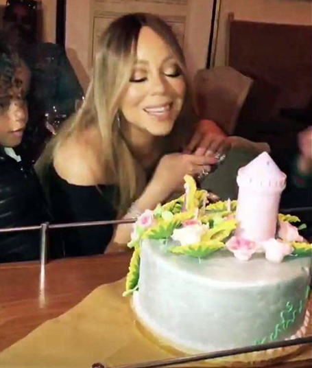 Mariah Carey blows out candles on princess castle cake | mcarchives.com