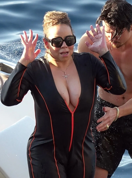 Mariah Carey unzipped in wetsuit puts on busty display