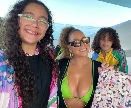 Mariah Carey teases cleavage in green bikini | mcarchives.com